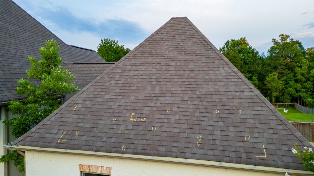 Roof with hail damage and marking from hail insurance inspection