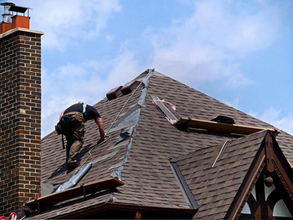 man replacing roof