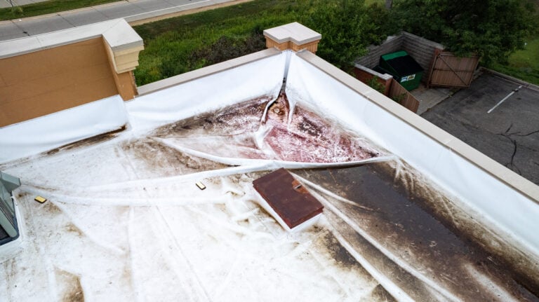 Damaged Commercial Flat Roof with Ponding Water and Stains