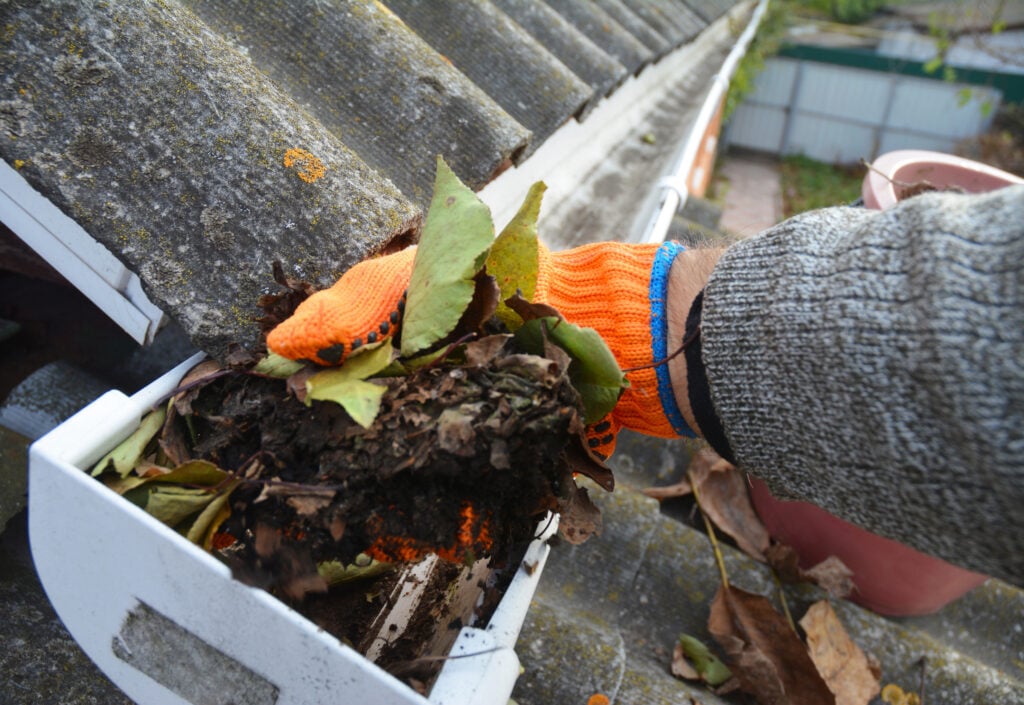 Cleaning a clogged roof gutter