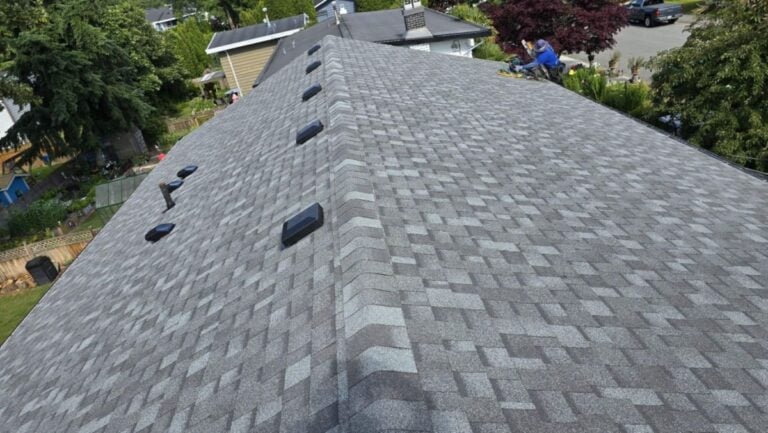 asphalt shingle roof replacement worker on top of shingles roof