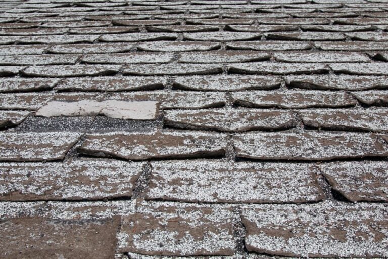 curling shingles white and brown old roof