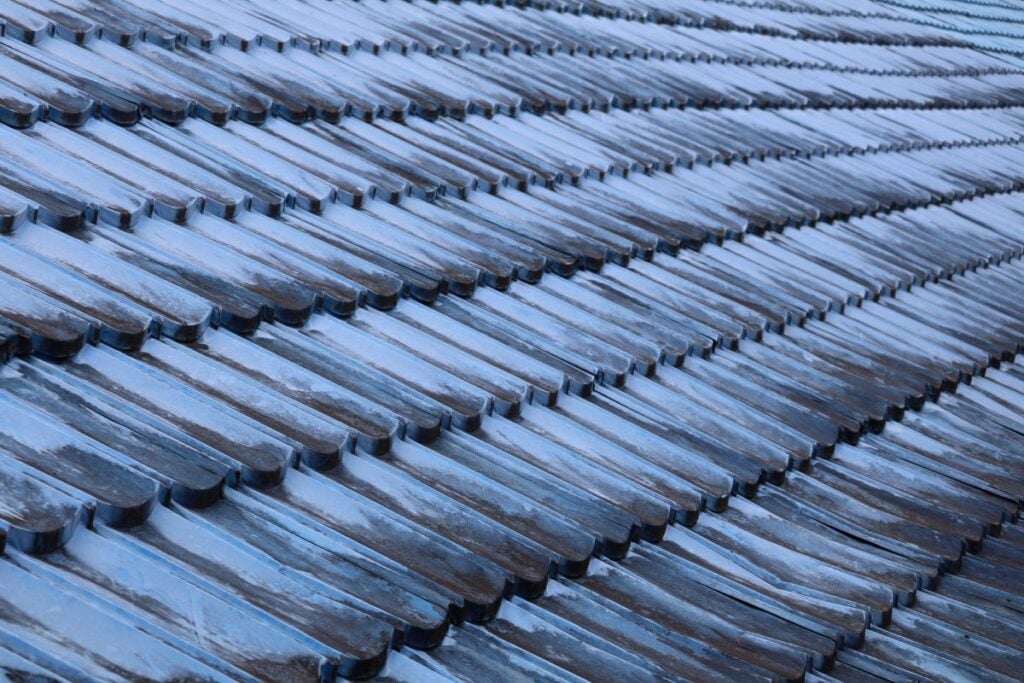 black streaks on roof blue ceramic tiles close up