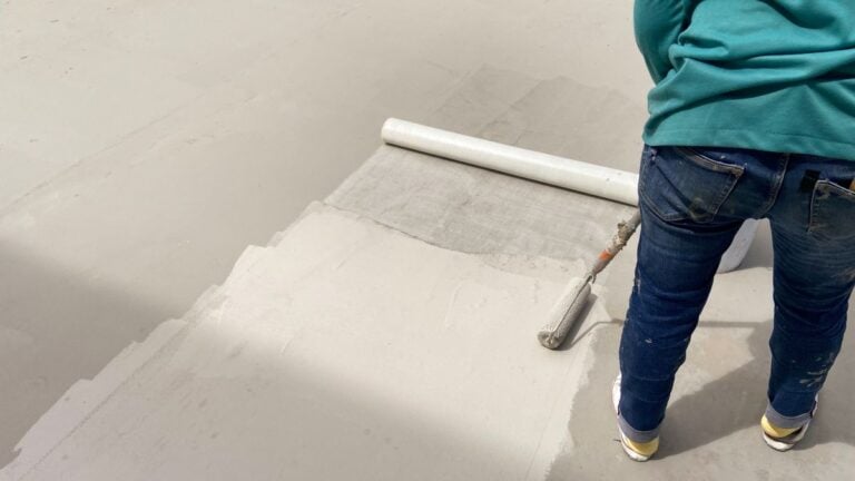 flat roof coating options worker applying white cover