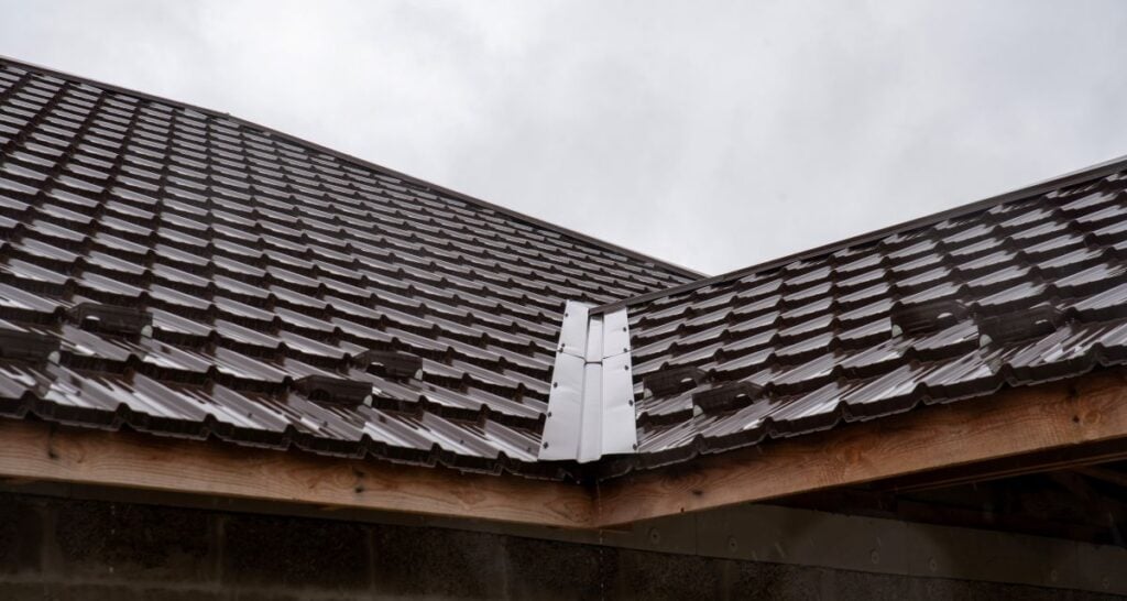 metal roof valley brown metallic tiles cloudy sky