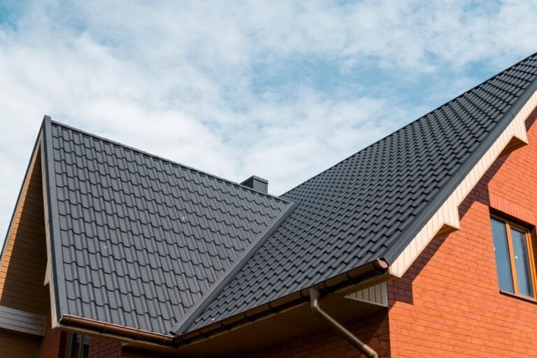 metal roof valley dark grey tiles and orange bricks