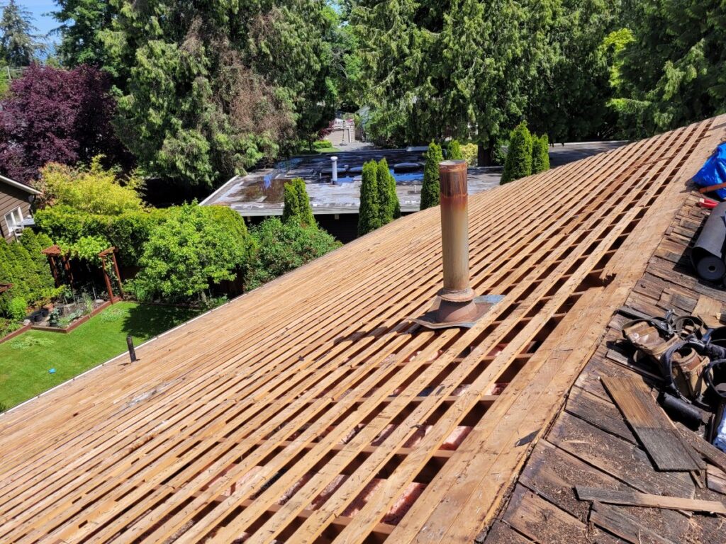 Army Roofing working on a roof replacement