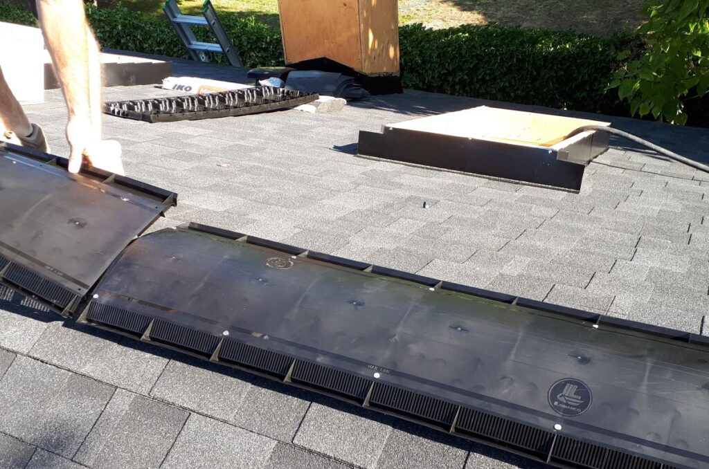 Army Roofing installing shingles on a roof ridge